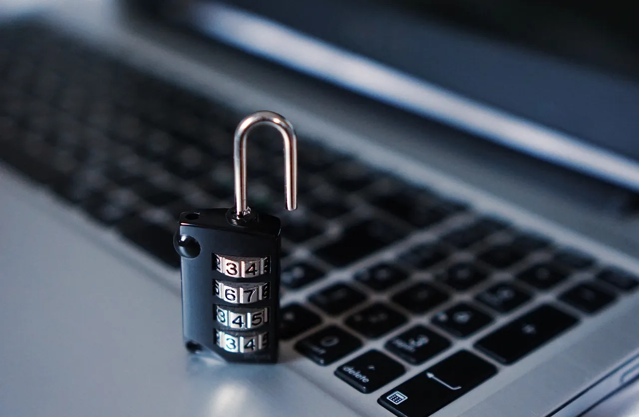 Padlock resting on a computer keyboard representing cybersecurity and security inspection